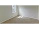 Bedroom features neutral paint, carpet floors, and a window allowing ample natural light at 415 Parkdale Dr # 12D, Charleston, SC 29414