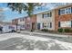 Exterior view of townhome units with brick and siding, front door access, and parking at 415 Parkdale Dr # 12D, Charleston, SC 29414