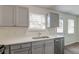 Kitchen boasts modern gray cabinets, stainless steel appliances, and quartz countertops at 415 Parkdale Dr # 12D, Charleston, SC 29414