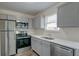 Modern kitchen with stainless steel appliances and gray cabinets at 415 Parkdale Dr # 12D, Charleston, SC 29414