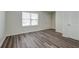Bright living room with wood-look flooring and large window at 415 Parkdale Dr # 12D, Charleston, SC 29414