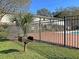 Community pool area with brick pavers, BBQ, black metal fence, and lush landscaping for residents at 415 Parkdale Dr # 12D, Charleston, SC 29414