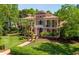 Aerial view of the home highlighting the expansive lawn, meticulous landscaping, and the home's architecture at 421 Royal Assembly Dr, Charleston, SC 29492