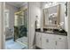 Bathroom with granite countertop, white cabinets, framed mirror, and glass-enclosed shower at 421 Royal Assembly Dr, Charleston, SC 29492