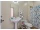 Cozy bathroom featuring a pedestal sink, toilet, and shower with decorative curtain at 421 Royal Assembly Dr, Charleston, SC 29492