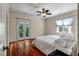 Bright bedroom featuring hardwood floors, a ceiling fan, and double doors to a balcony at 421 Royal Assembly Dr, Charleston, SC 29492