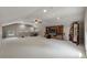 Spacious carpeted bonus room with a large TV, shelving, and plenty of open space at 421 Royal Assembly Dr, Charleston, SC 29492