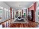 Elegant dining room featuring a crystal chandelier, hardwood floors, and large windows with red drapes at 421 Royal Assembly Dr, Charleston, SC 29492