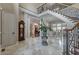 Spacious entry featuring staircase with decorative iron railing, travertine floors and view into other living areas at 421 Royal Assembly Dr, Charleston, SC 29492
