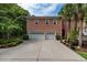 Exterior view of the house showcasing the garage, driveway and landscaping at 421 Royal Assembly Dr, Charleston, SC 29492