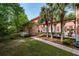 Side view of property showcasing a lush lawn, stately columns, a patio and mature landscaping at 421 Royal Assembly Dr, Charleston, SC 29492