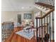 Spacious foyer with hardwood floors, grand staircase with wrought iron, and refined decor at 421 Royal Assembly Dr, Charleston, SC 29492