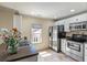 Well-lit kitchen featuring stainless steel appliances, white cabinets, and a window view at 421 Royal Assembly Dr, Charleston, SC 29492