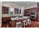 Well-appointed kitchen with dark wood cabinets, granite countertops, and a center island with seating at 421 Royal Assembly Dr, Charleston, SC 29492