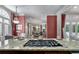 Luxurious kitchen with a center island cooktop, offering a view into the elegant dining room at 421 Royal Assembly Dr, Charleston, SC 29492