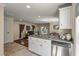 Open kitchen area with tile floors, white cabinets, stainless steel appliances, and breakfast bar at 421 Royal Assembly Dr, Charleston, SC 29492
