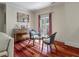 Cozy living area featuring a piano, seating, balcony access, and gleaming hardwood floors at 421 Royal Assembly Dr, Charleston, SC 29492