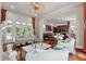 Bright living room with hardwood floors, white sofas, a ceiling fan, and a view into the kitchen at 421 Royal Assembly Dr, Charleston, SC 29492