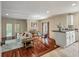 Comfortable living room featuring hardwood floors, a sofa, a piano, and a dining area at 421 Royal Assembly Dr, Charleston, SC 29492