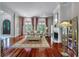 Elegant living room featuring hardwood floors, fireplace and grand windows providing an abundance of natural light at 421 Royal Assembly Dr, Charleston, SC 29492