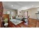 Comfortable living room featuring hardwood floors, a sofa, a piano, and a dining area at 421 Royal Assembly Dr, Charleston, SC 29492