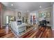 Cozy living room with hardwood floors, a fireplace, and views into the dining room at 421 Royal Assembly Dr, Charleston, SC 29492