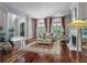 Elegant living room featuring hardwood floors, fireplace and grand windows providing an abundance of natural light at 421 Royal Assembly Dr, Charleston, SC 29492