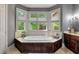 Large bathroom with soaking tub, double vanity, and updated fixtures plus a big window providing lots of natural light at 421 Royal Assembly Dr, Charleston, SC 29492