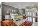 A spacious bedroom with hardwood floors, fireplace, king bed, and french doors letting in plenty of natural light at 421 Royal Assembly Dr, Charleston, SC 29492