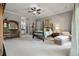 Spacious main bedroom features neutral carpet, four-poster bed, and ensuite bathroom at 421 Royal Assembly Dr, Charleston, SC 29492