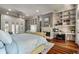 Spacious main bedroom with hardwood floors, a fireplace, built-in shelves, and backyard access at 421 Royal Assembly Dr, Charleston, SC 29492