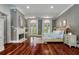 A spacious bedroom with hardwood floors, fireplace, king bed, and french doors letting in plenty of natural light at 421 Royal Assembly Dr, Charleston, SC 29492