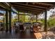 Covered outdoor living space with comfortable seating offers a relaxing spot with views at 421 Royal Assembly Dr, Charleston, SC 29492
