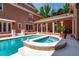 Inviting backyard pool and spa area surrounded by a patio and access to the home's veranda at 421 Royal Assembly Dr, Charleston, SC 29492