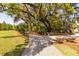 Scenic walking path with lush greenery and shade offers a tranquil escape outdoors at 421 Royal Assembly Dr, Charleston, SC 29492