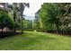 Spacious front yard featuring mature trees and manicured landscaping at 421 Royal Assembly Dr, Charleston, SC 29492