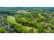 Aerial image capturing the neighborhood's proximity to a golf course with lush greens and tree-lined fairways at 4403 Wild Thicket Ln, North Charleston, SC 29420