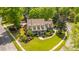 Beautiful aerial shot of the landscaped front yard, complemented by the home's charming facade and manicured lawn at 4403 Wild Thicket Ln, North Charleston, SC 29420