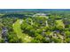 Aerial perspective showcasing the neighborhood's proximity to a lush golf course and tree-lined streets at 4403 Wild Thicket Ln, North Charleston, SC 29420