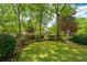 Lush backyard featuring mature trees and well-placed shrubs that create a tranquil outdoor space with natural beauty at 4403 Wild Thicket Ln, North Charleston, SC 29420