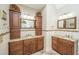 A spacious bathroom featuring dual vanities with granite countertops and wood cabinetry at 4403 Wild Thicket Ln, North Charleston, SC 29420