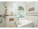 Bright bathroom with a glass shower, a garden tub, and a large window at 4403 Wild Thicket Ln, North Charleston, SC 29420