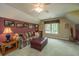 Cozy bonus room with unique decorations and a comfortable couch and ottoman at 4403 Wild Thicket Ln, North Charleston, SC 29420