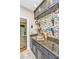 Stylish butler's pantry with custom cabinets, granite countertops, and decorative backsplash at 4403 Wild Thicket Ln, North Charleston, SC 29420
