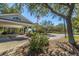 The clubhouse entrance offers a covered drop-off, landscaped areas, and a prominent American flag on a clear day at 4403 Wild Thicket Ln, North Charleston, SC 29420