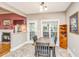 Bright dining area with natural light, fireplace, and access to an outdoor area at 4403 Wild Thicket Ln, North Charleston, SC 29420