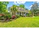 Inviting two-story home with a lush lawn and vibrant landscaping enhancing its curb appeal at 4403 Wild Thicket Ln, North Charleston, SC 29420
