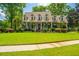 Charming two-story home featuring mature landscaping and a welcoming front porch at 4403 Wild Thicket Ln, North Charleston, SC 29420