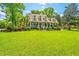 Stunning two-story home with a lush green lawn and a charming front porch at 4403 Wild Thicket Ln, North Charleston, SC 29420
