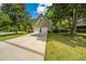 Home with a two-car garage, driveway, and manicured lawn, enhanced by mature trees in a suburban setting at 4403 Wild Thicket Ln, North Charleston, SC 29420
